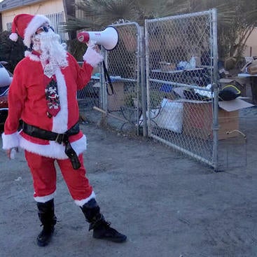 MS2 Cintya Beltran Sanchez dressed as Santa Claus holding a megaphone