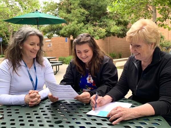 Escalona family reviewing Standardized Patient resources at a table