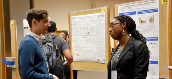 Two students chatting about research