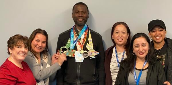 Isaac Owusu-Frimpong with his marathon medals