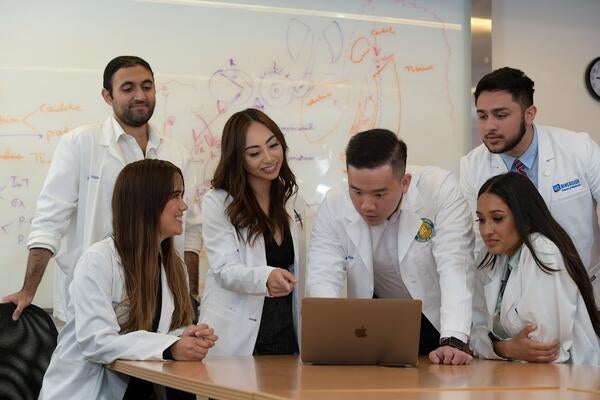 Students looking at a computer