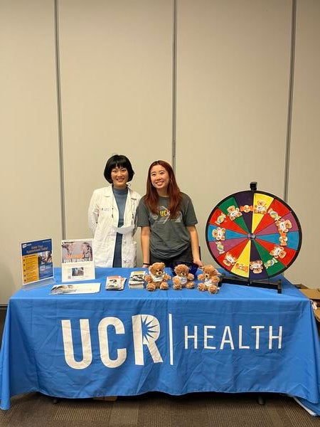 Dr. Yamaguchi at a UCR Health table