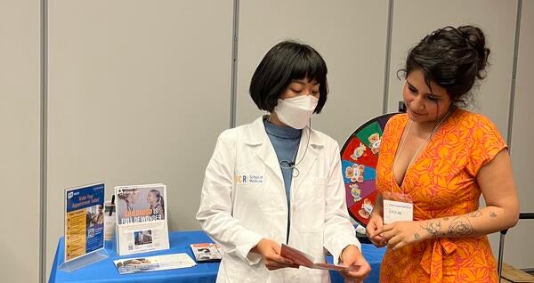 Dr. Yamaguchi at a UCR Health table