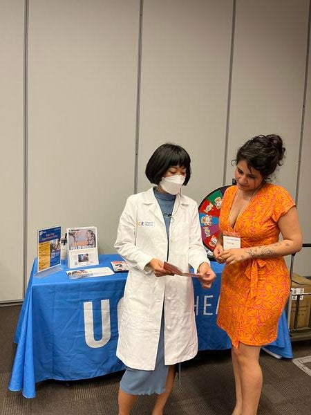 Dr. Yamaguchi at a UCR Health table