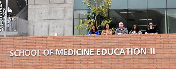 the facilities team outside the SOM Ed II building