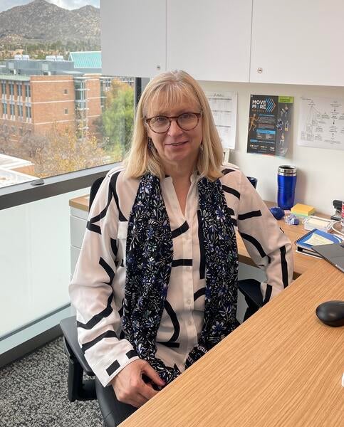 Iryna Ethell sitting at her desk