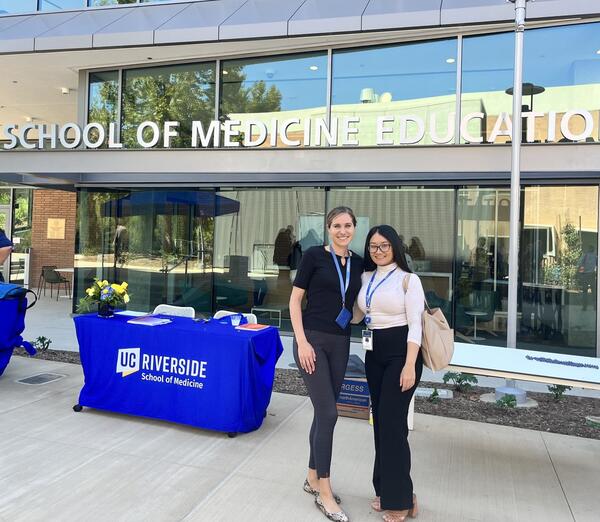 Arpy Barsemian and another administrative fellow in front of the SOM Ed II building