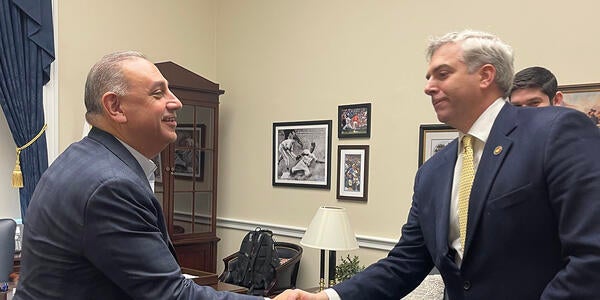 Scott Pegan shaking hands with Representative Gil Cisneros.