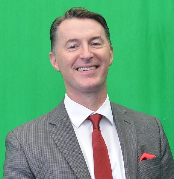 Declan McCole in front of a green background