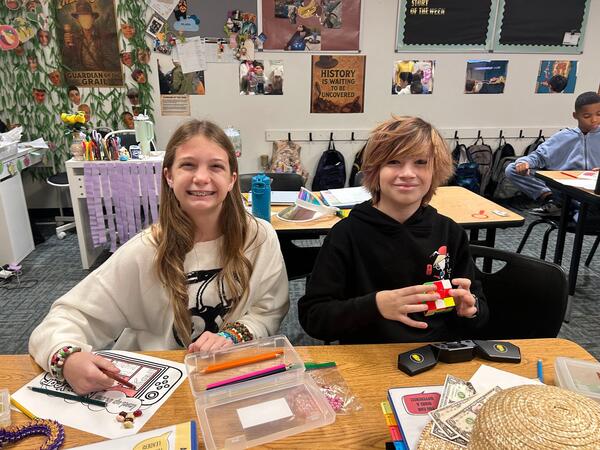 Two Craig School Students working at a table