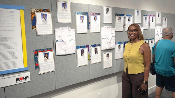 Michelle Burroughs in front of an exhibit