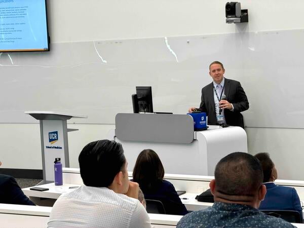 Meth summit attendees sitting at tables listening to the keynote speaker