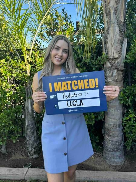 Helen Setaghiyan holding an "I matched!" sign