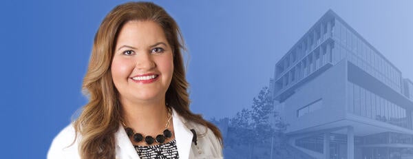 Denise Martinez, MD, in front of the SOM Ed Building 2