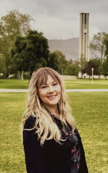 Alicia Junker standing in front of the bell tower at UCR