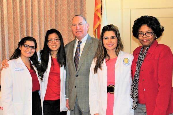  Class of 2018 students Katherine Tsai, MD, Mayra Hernandez Schulte, MD, and Morvarid Tavassoli, MD, with retired Calfornia Senator Richard Roth and Desiree Reedus, MD, MPH,  at the Doctor's Corner Woman's  Community Symposium at the Riverside Woman's Club