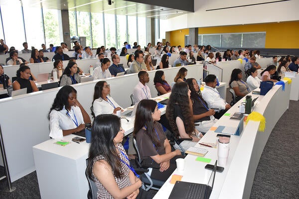 Medical students listen durin orientation