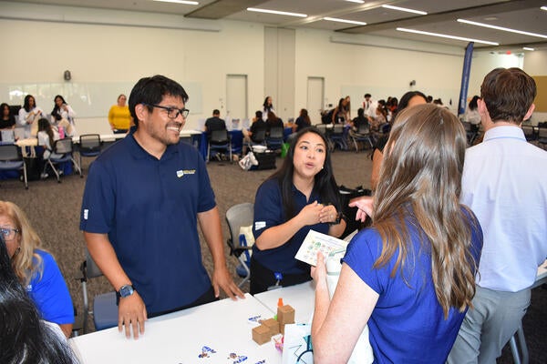 Darnell Sy, right, speaks to students as Humberto Santiago looks on.
