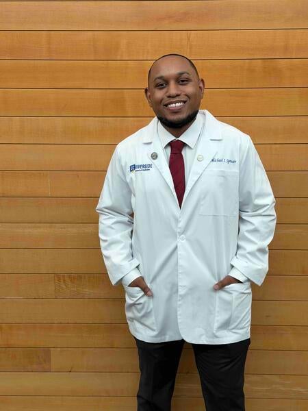Michael Spencer wearing a white coat