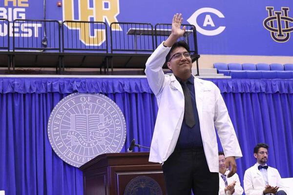 Carlos Diaz waves during the 2026 white coat ceremony