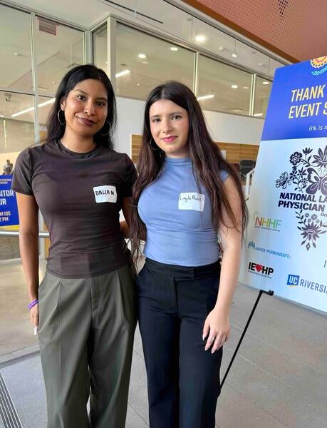 Dalia Molina and Layla Ruiz stand next to each other at NLPD 2026