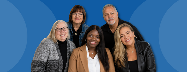 Office of Faculty Development group photo against a blue background