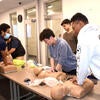 Guests learning how to do CPR at the 2023 Open House