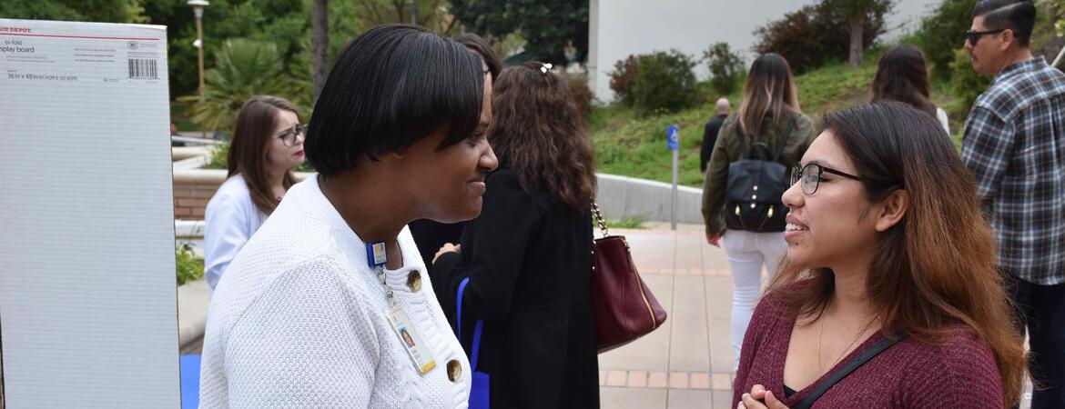 Teresa Cofield talking to a woman