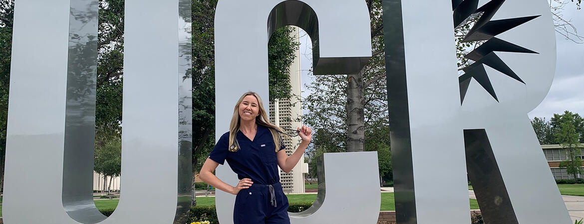 Skylar Rains in front of the UCR Sign