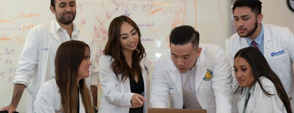 Students looking at a computer