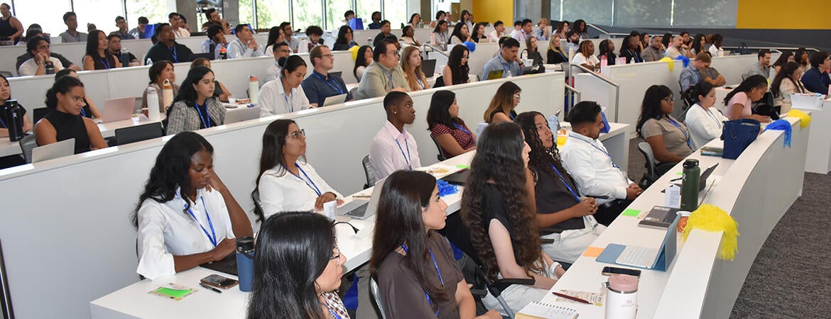 Medical students listen durin orientation