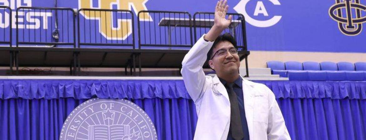 Carlos Diaz waves during the 2026 white coat ceremony