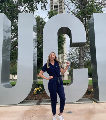Skylar Rains in front of the UCR Sign