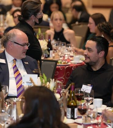 Jarrod McNaughton speaking to a student at the 2022 Gala