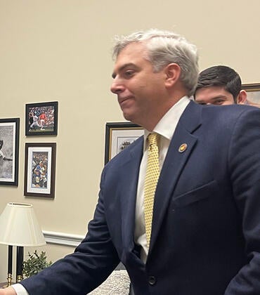 Scott Pegan shaking hands with Representative Gil Cisneros.
