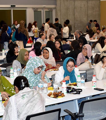 guests enjoy dinner at the Iftar celebration at the UCR School of Medicine