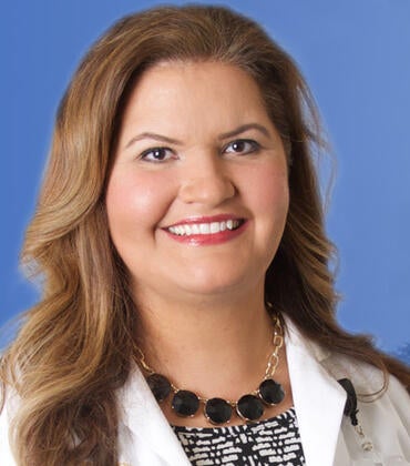 Denise Martinez, MD, in front of the SOM Ed Building 2