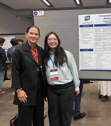 Stephanie Zheng standing in front of a research poster