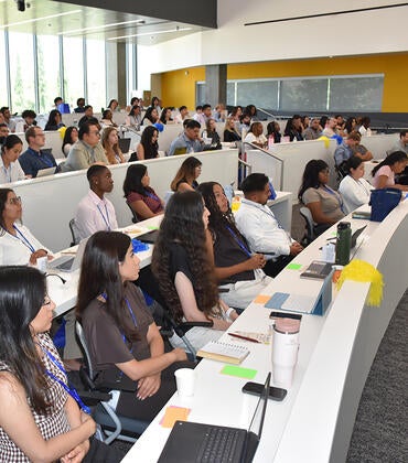Medical students listen durin orientation