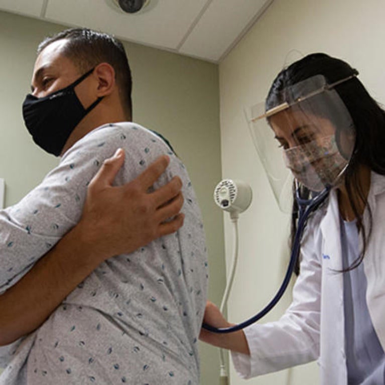 A medical student listening to the heartbeat of a standardized patient