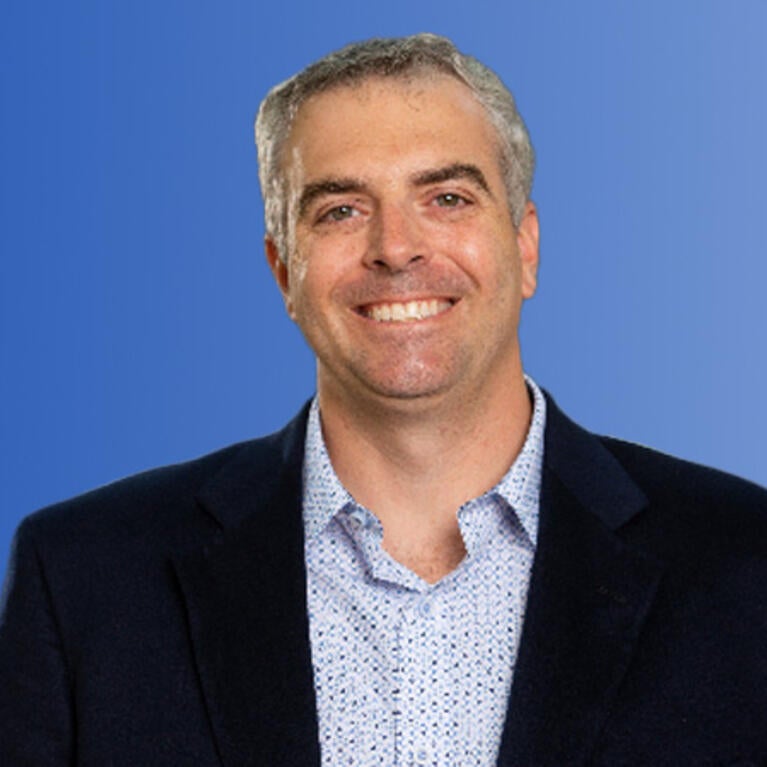 scott pegan in front of a blue background