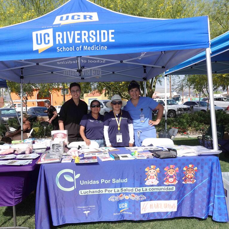 Joslyn Santana, far right, and others tabling for Unidas Por Salud