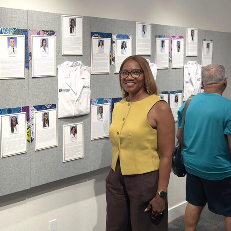 Michelle Burroughs in front of an exhibit