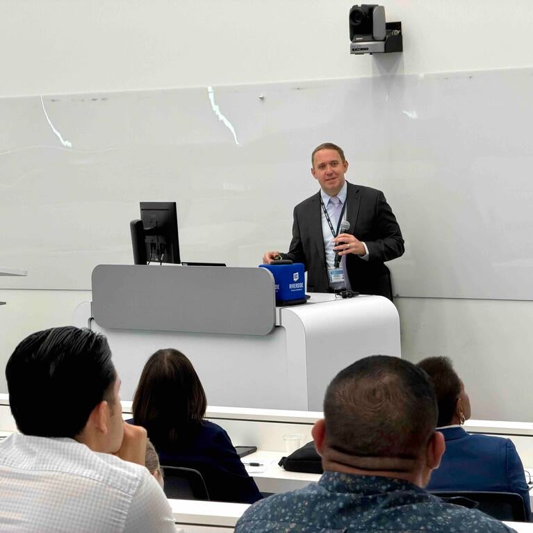 Meth summit attendees sitting at tables listening to the keynote speaker