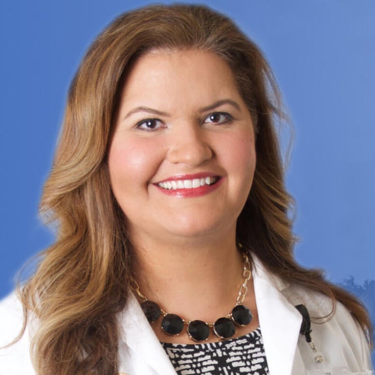 Denise Martinez, MD, in front of the SOM Ed Building 2