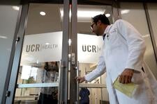 doctor opening door to UCR Health Offices