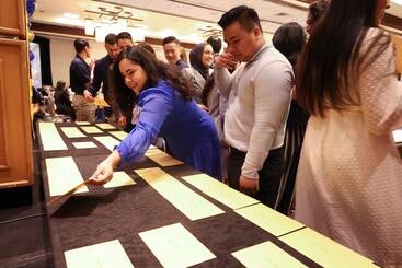 Students retrieving their envelopes from the table