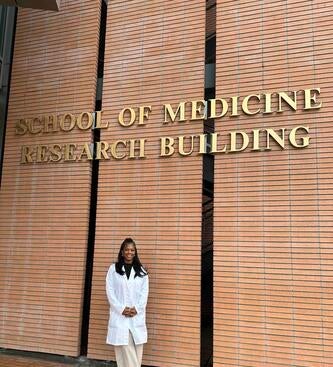 Keziyah Yisrael standing in front of the SOM Research Building