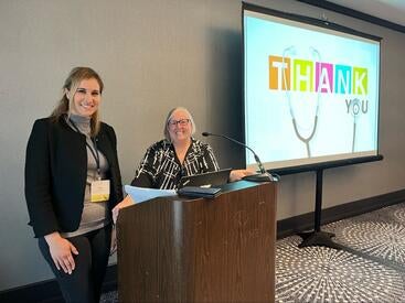 Arpy Barsemian and Dr. Rosemary Tyrrell at a conference