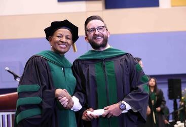 James-Elkins Dean Deas standing next to James Elkins at commencement 2025